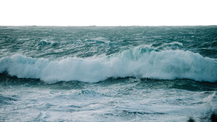 Powerful sea waves crashing against rocky shorelines at dusk isolated on transparent background