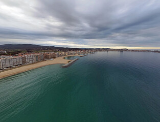Aerial cityscape view of beach and Mediterranean Sea along Costa Brava in Palamos Catalonia