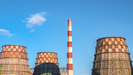Power plant cooling towers under blue sky