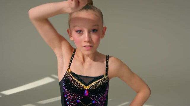 Little girl child kid daughter Caucasian schoolgirl young athlete teenager sport gymnast artistic female ballet dancer sportswoman perform swirling spinning gymnastic tape dance studio choreography