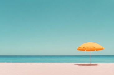 A bright yellow umbrella on a serene beach under a clear blue sky in midday light