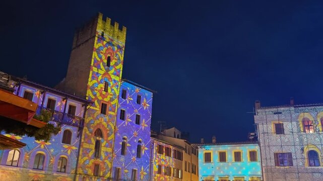 Panoramic view of the main square of Arezzo (Piazza Grande) during christmas time with beautiful lights in the palace, Tuscany, Italy