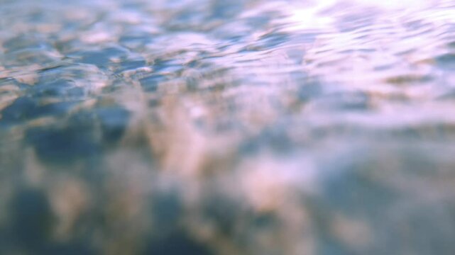 dynamic close-up of rolling waves on a smooth stone in slow motion