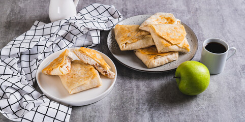 Appetizing envelopes with cottage cheese and apple in pita bread on a plate web banner