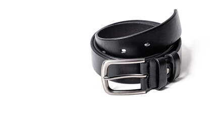 Obraz premium Twisted black leather belt with matted metal buckle isolated on white background. Fastened fashionable unisex, man or woman accessory for trousers, jeans, dress. Male luxury strap. Haberdashery goods