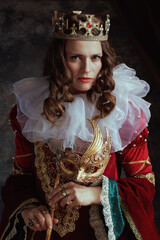 medieval queen in red dress with venetian mask