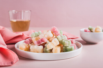Dry frozen gummy bears candies on plate on table