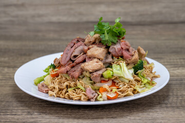 Beef Chow fun rice noodles piled high on the plate for a hearty Vietnamese Cuisine meal of chow mein