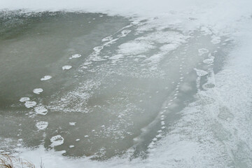 Polar footprints across a frozen pond on the tundra of Churchill Manitoba Canada