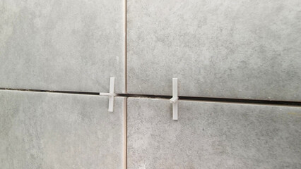 Tiles and tile spacers being installed during renovation
