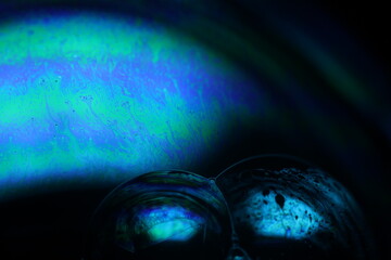 Bright rainbow reflection of liquid in macro, white colors, surrealistic background, fantastic...