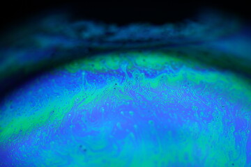 Bright rainbow reflection of liquid in macro, dispersion, surrealistic background, fantastic smooth movement	