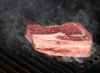 Searing and smoking ribeye steaks on grill