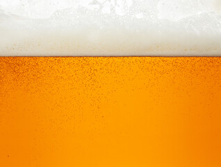 Close up background of beer with bubbles in glass