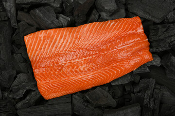 Cooking raw salmon fish fillet on charcoal