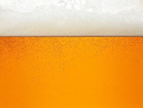 Close up background of beer with bubbles in glass