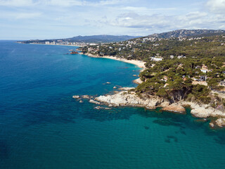 Aerial cityscape view of beach and Mediterranean Sea along Costa Brava in Palamos Catalonia
