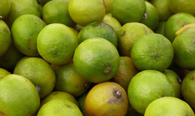 Fresh green lime fruits on market stall