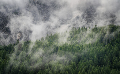 Alpine foggy landscape of Marmolada mountain in summer, Dolomites, Italy, Europe