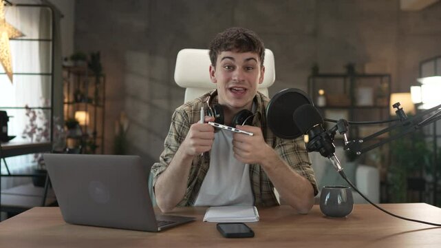 Young man technology blogger record video blog or v-log of new gadget