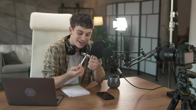 Young man technology blogger record video blog or v-log of new gadget