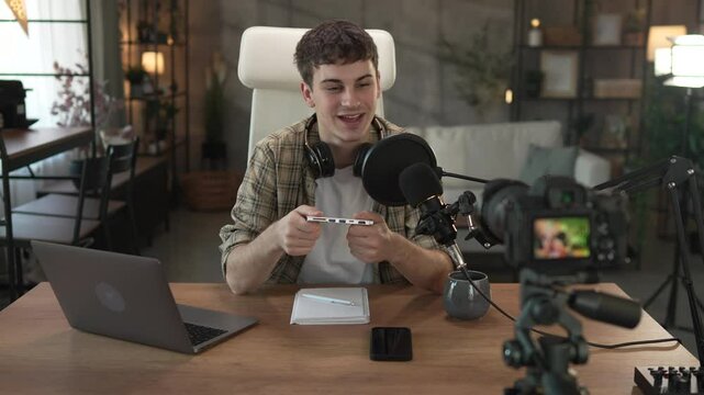 Young man technology blogger record video blog or v-log of new gadget
