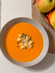 pumpkin soup in a bowl on the table