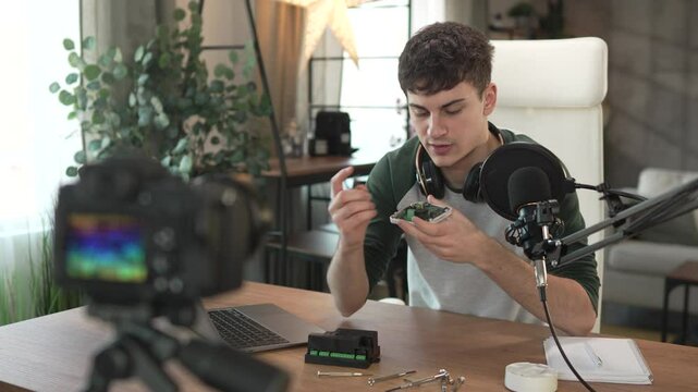 Young man technology blogger record video blog or v-log set up device