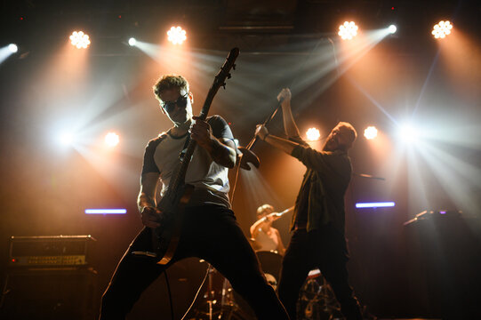 Guitarist and singer performing with passion on stage