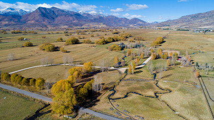 landscape in the mountains, aerial of fields and mountains, perspective, farm country from above