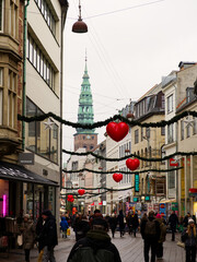 Copenhagen, Denmark - December 7, 2023: Crowded Copenhagen city center streets with pedestrians enjoying Christmas atmosphere with decorations