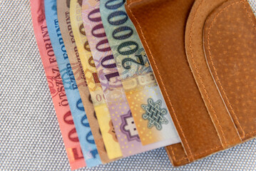 Hungarian forint banknotes in a brown leather wallet.