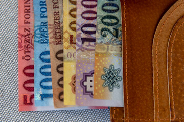 Hungarian forint banknotes in a brown leather wallet.