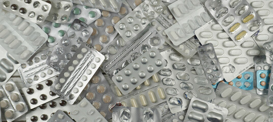 Obraz premium Empty pill blisters. Used blister packs from pills, danger of overdose, drug abuse. 