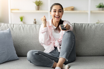 Having Fun. Portrait of optimistic enthusiastic Excited young woman watching TV show or movie,...