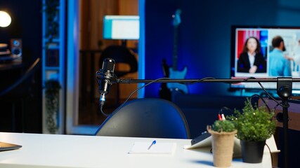 Laptop on desk in empty home production studio with podcast equipment technology recording sound...