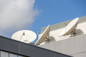 Satellite dishes pointing to the sky on building roof for communication