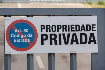 Fototapeta premium Private property sign on metal gate in portuguese language