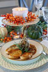 Roasted duck soup stew with garlic bread on fine China bowl and plate and silver spoon