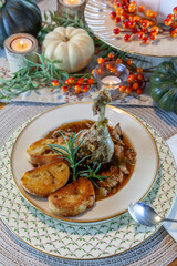 Roasted duck soup stew with garlic bread on fine China bowl and plate and silver spoon