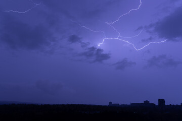 bright lightning in the night sky over the city