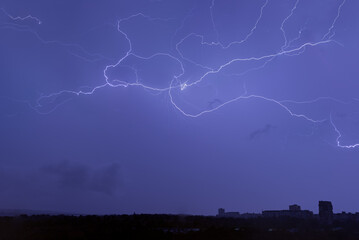 bright lightning in the night sky over the city