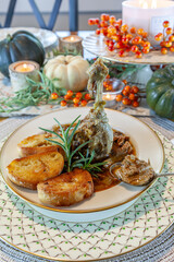 Roasted duck soup stew with garlic bread on fine China bowl and plate and silver spoon