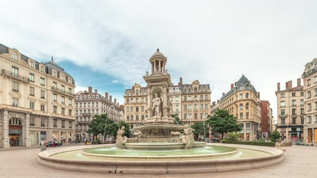 Hyperlapse of Place des Jacobins in Lyon, France, featuring the ornate Fontaine des Jacobins surrounded by historic buildings. Bustling city square under a cloudy sky timelapse