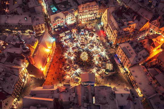 Aerial night View of Tallinn with the Town Hall Square in winter, roofs with snow, Christmas mood