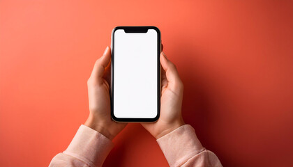 A woman hands hold a smartphone with a blank screen against a bright coral background. Generative AI.