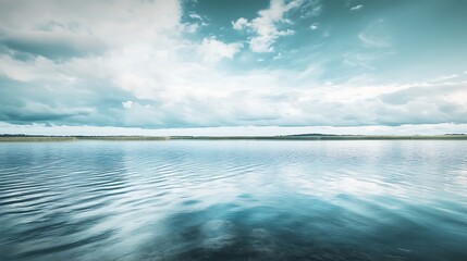 Calm lake under a cloudy sky. Tranquil nature scene.