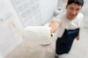 painter man, brush in hand for products to restore and paint the wall, indoor the building site of a house, wall during painting, renovation, painting, contractor, Architect, construction worker