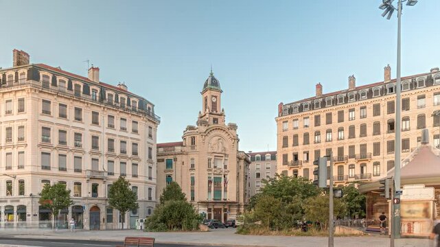 Hyperlapse of Place Antonin Jutard and the Mutuality Palace facade from the waterfront near Guillotiere Bridge in Lyon, France. Traffic flows on Quai Victor Augagneur under a blue sky timelapse