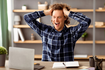 Obraz premium Business Success And Luck. Excited Businessman Looking At Laptop Touching Hair In Excitement Reading Great News Online Sitting At Workplace In Modern Office. Selective Focus